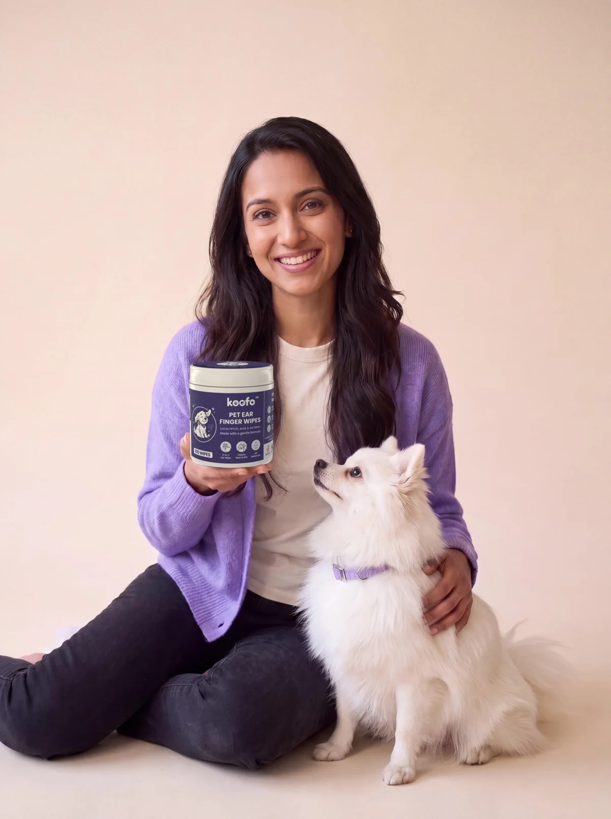 Maya holding a can of Koofo Pet Ear Finger Wipes next to Mochi